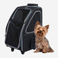 Petique 5-in-1 dog carrier in black with black and white trim. Small dog sitting outside the pet carrier.