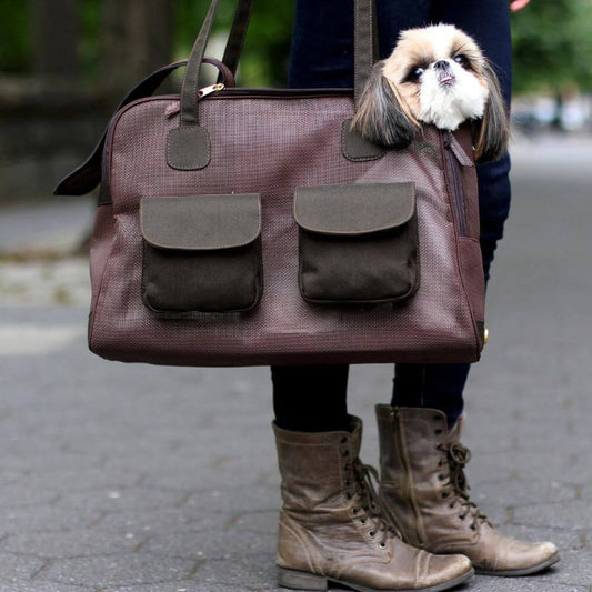 Small dog being carried in the Canine Styles all mesh brown purse for pets.