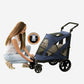 Person pressing the release button on the Pet Gear Excursion dog stroller.