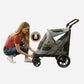 Person opening the canopy of the Pet Gear Excursion dog stroller with a push of a button.