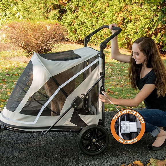 Person is pressing on the push button entry of the Pet Gear Expedition dog stroller.